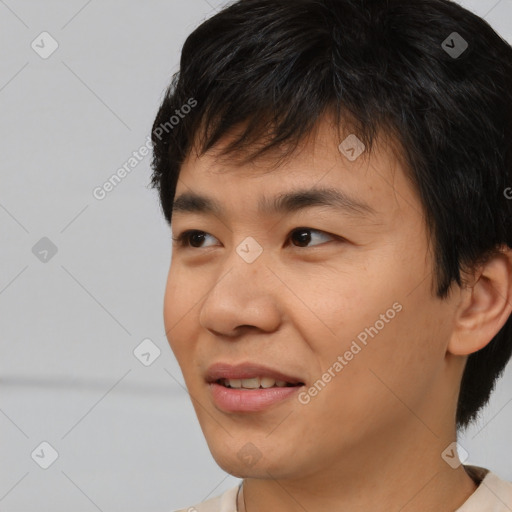 Joyful asian young-adult male with short  black hair and brown eyes