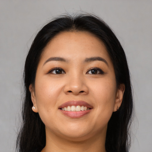 Joyful asian young-adult female with long  black hair and brown eyes