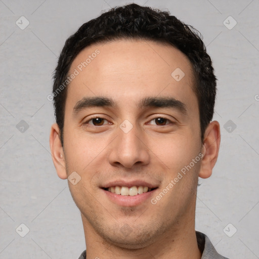 Joyful white young-adult male with short  black hair and brown eyes