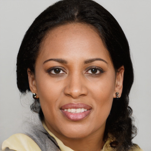 Joyful black young-adult female with medium  black hair and brown eyes