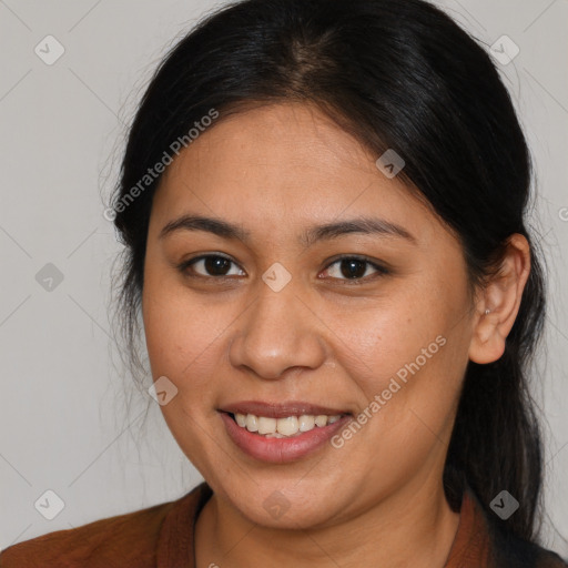 Joyful latino young-adult female with medium  brown hair and brown eyes