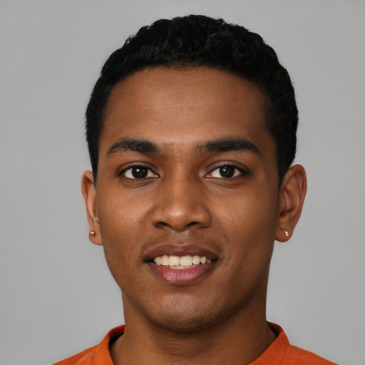 Joyful black young-adult male with short  black hair and brown eyes