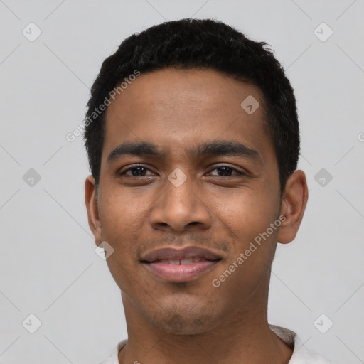 Joyful black young-adult male with short  black hair and brown eyes