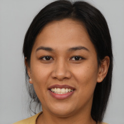 Joyful asian young-adult female with medium  brown hair and brown eyes