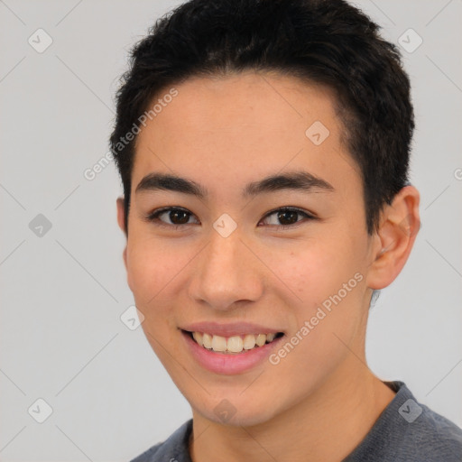 Joyful asian young-adult male with short  brown hair and brown eyes