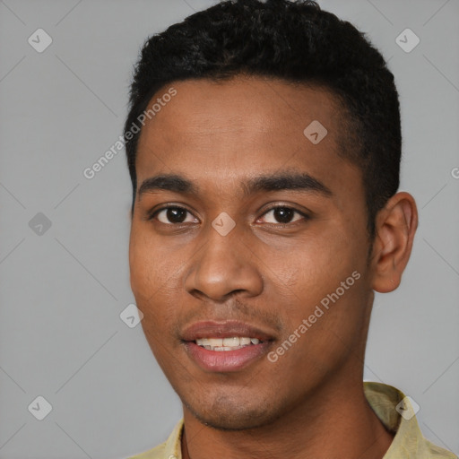 Joyful black young-adult male with short  black hair and brown eyes