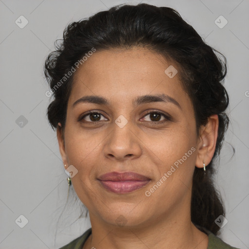 Joyful latino adult female with medium  brown hair and brown eyes