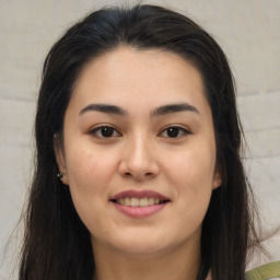 Joyful asian young-adult female with long  brown hair and brown eyes