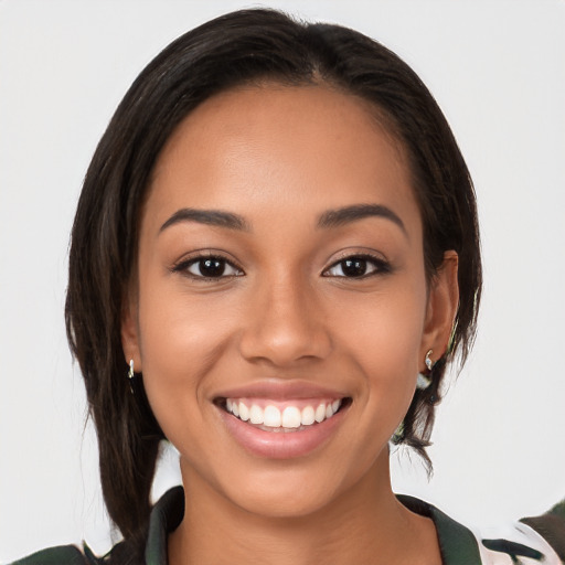 Joyful latino young-adult female with medium  brown hair and brown eyes