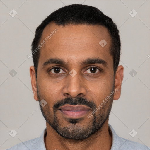 Joyful black young-adult male with short  black hair and brown eyes