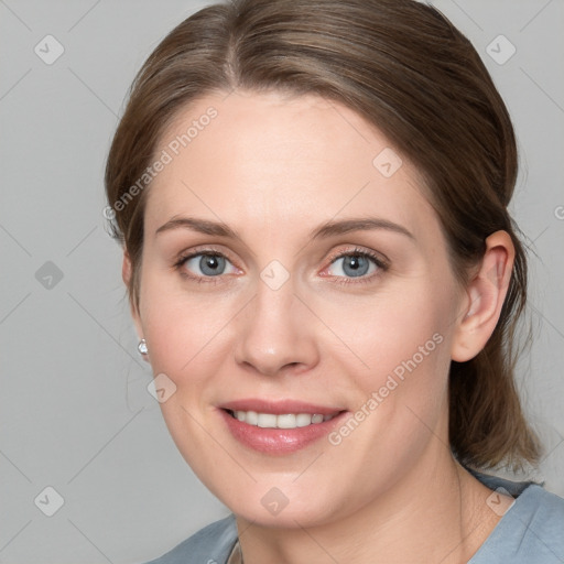 Joyful white young-adult female with medium  brown hair and blue eyes