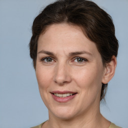 Joyful white adult female with medium  brown hair and grey eyes