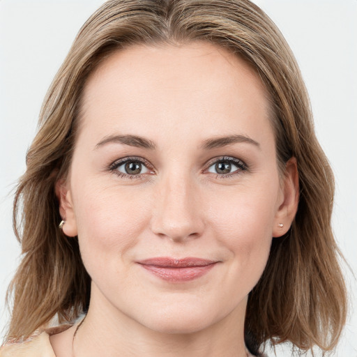 Joyful white young-adult female with medium  brown hair and blue eyes