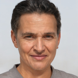 Joyful white middle-aged male with short  brown hair and brown eyes