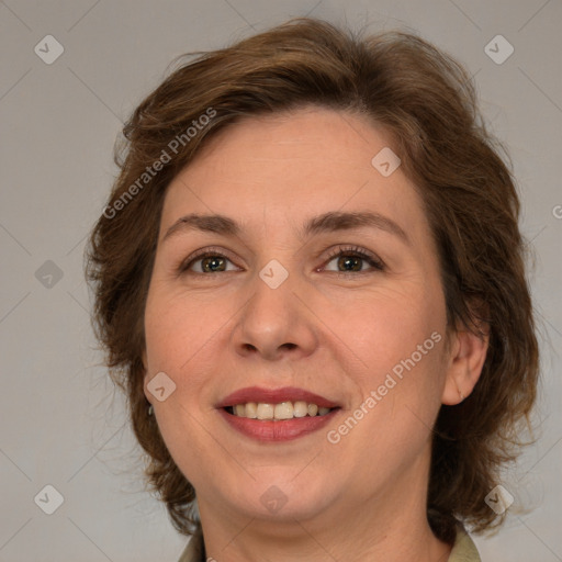 Joyful white adult female with medium  brown hair and green eyes