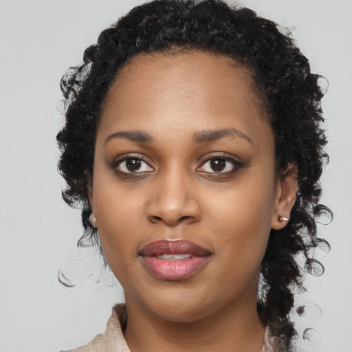 Joyful black young-adult female with medium  brown hair and brown eyes