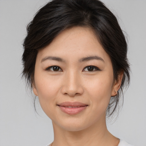 Joyful asian young-adult female with medium  brown hair and brown eyes