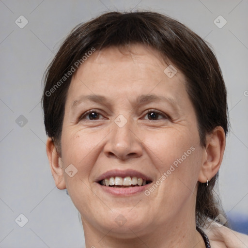 Joyful white adult female with medium  brown hair and brown eyes