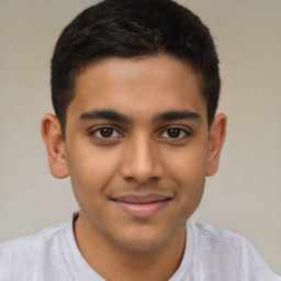 Joyful latino young-adult male with short  brown hair and brown eyes