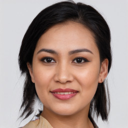 Joyful asian young-adult female with medium  brown hair and brown eyes