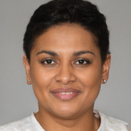 Joyful latino young-adult female with short  brown hair and brown eyes
