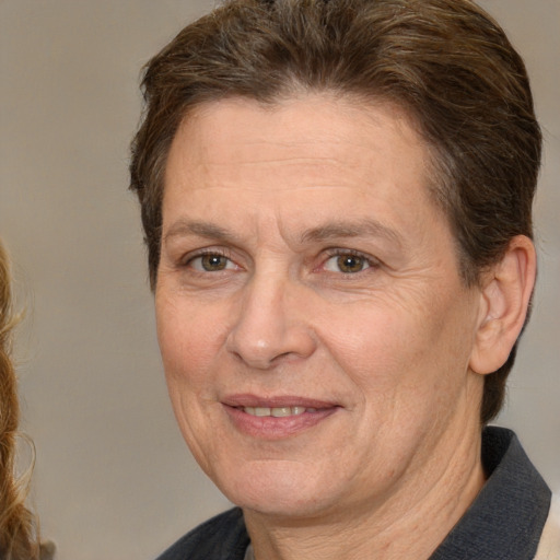 Joyful white adult female with short  brown hair and brown eyes