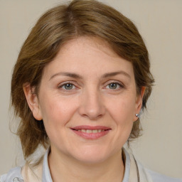 Joyful white adult female with medium  brown hair and grey eyes