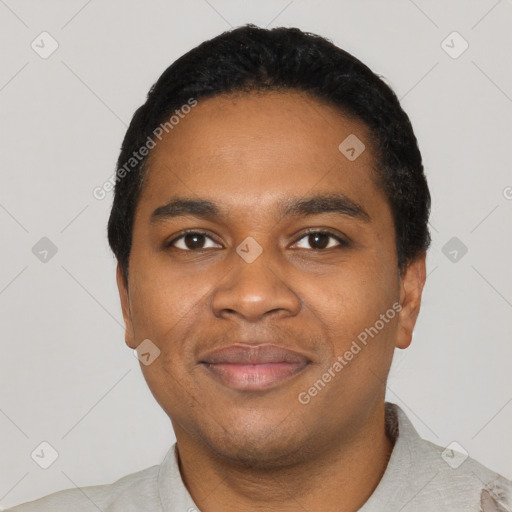 Joyful black young-adult male with short  black hair and brown eyes