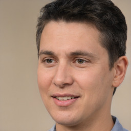 Joyful white adult male with short  brown hair and brown eyes