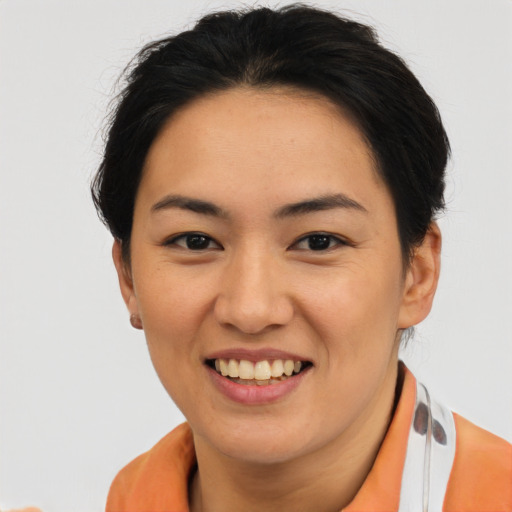 Joyful asian young-adult female with short  brown hair and brown eyes