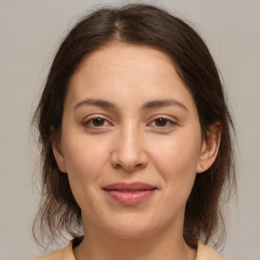 Joyful white young-adult female with medium  brown hair and brown eyes