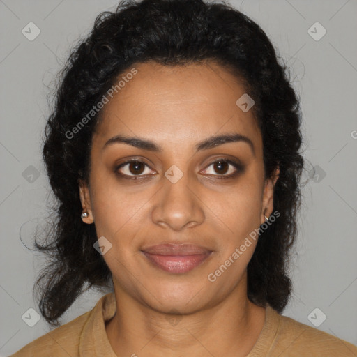 Joyful black young-adult female with long  black hair and brown eyes