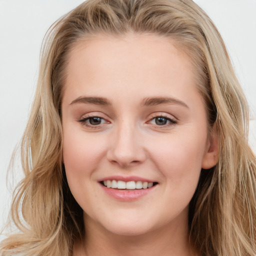 Joyful white young-adult female with long  brown hair and blue eyes