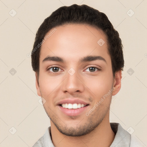 Joyful white young-adult male with short  black hair and brown eyes