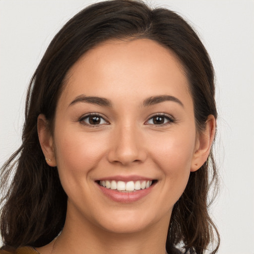 Joyful white young-adult female with long  brown hair and brown eyes