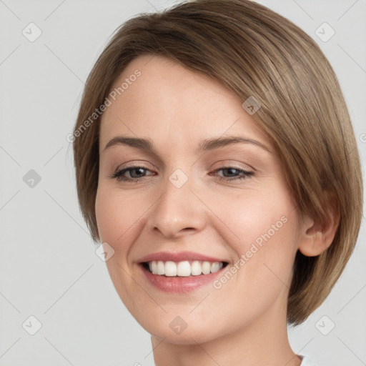 Joyful white young-adult female with medium  brown hair and grey eyes