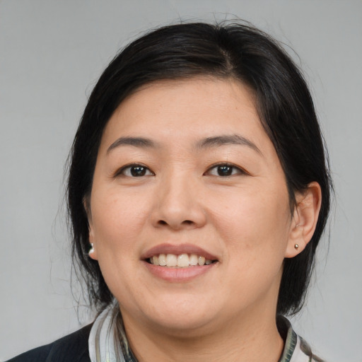 Joyful white young-adult female with medium  black hair and brown eyes