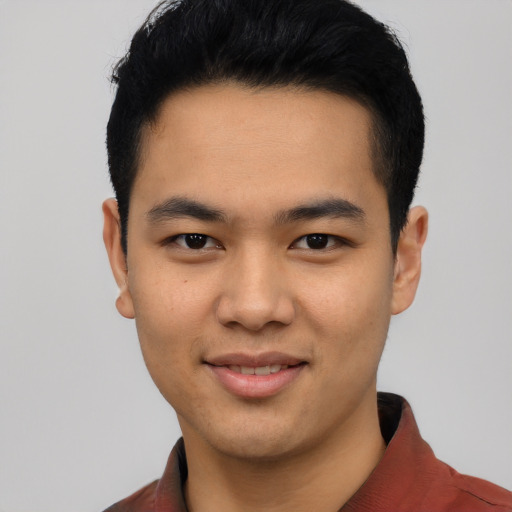 Joyful asian young-adult male with short  black hair and brown eyes
