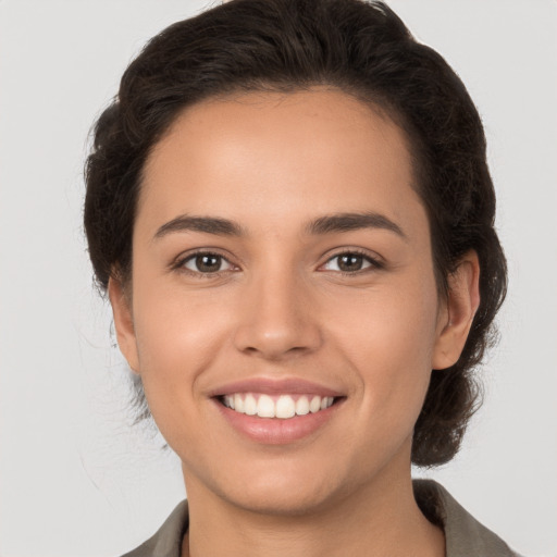 Joyful white young-adult female with medium  brown hair and brown eyes