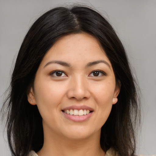 Joyful asian young-adult female with long  brown hair and brown eyes