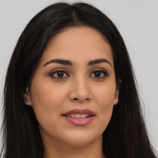 Joyful latino young-adult female with long  brown hair and brown eyes