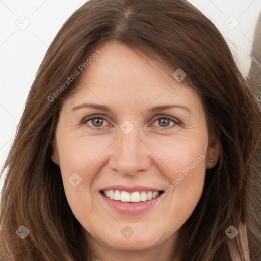 Joyful white adult female with long  brown hair and brown eyes