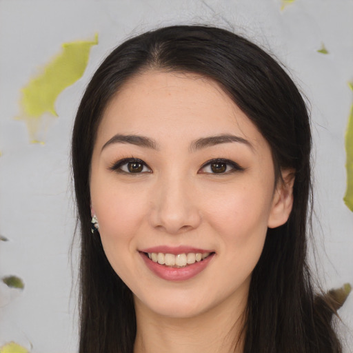 Joyful white young-adult female with long  black hair and brown eyes