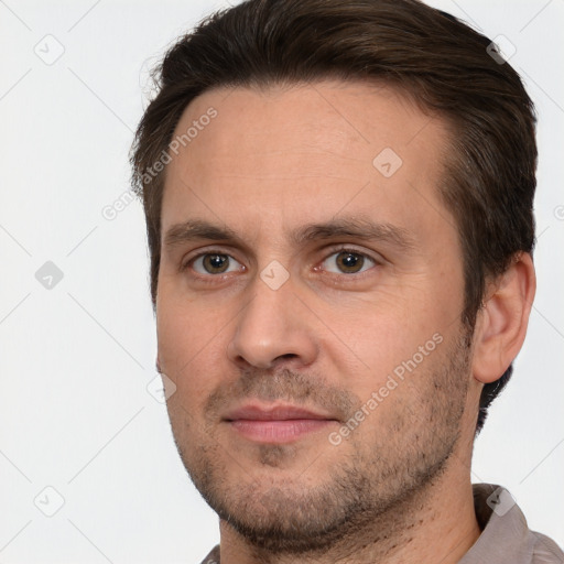 Joyful white adult male with short  brown hair and brown eyes