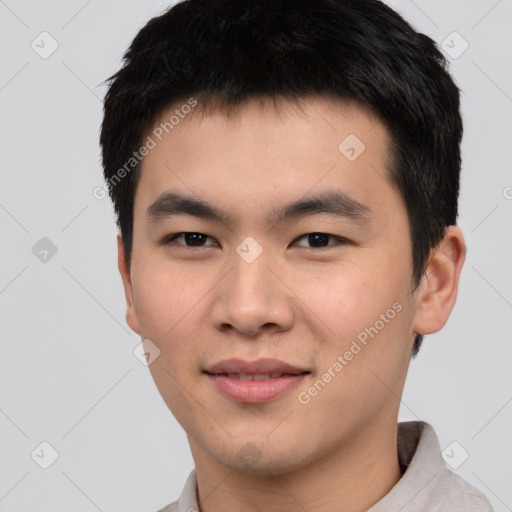 Joyful asian young-adult male with short  black hair and brown eyes