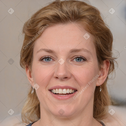 Joyful white adult female with medium  brown hair and blue eyes