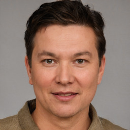 Joyful white adult male with short  brown hair and grey eyes