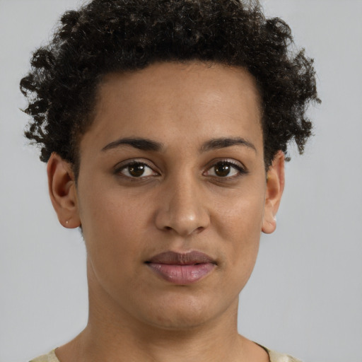 Joyful black young-adult female with short  brown hair and brown eyes
