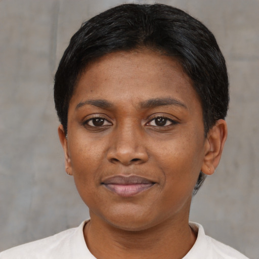 Joyful black young-adult female with short  black hair and brown eyes
