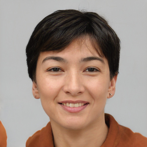 Joyful asian young-adult female with short  brown hair and brown eyes